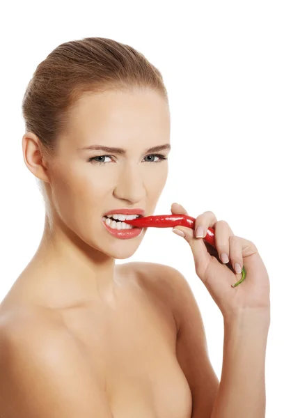 Woman with chili pepper in mouth. — Stock Photo, Image