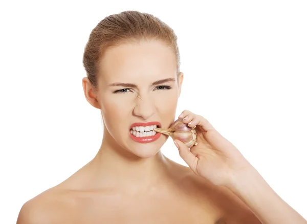 Woman with raw garlic in mouth. — Stock Photo, Image