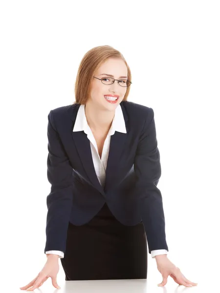 Young attractive business woman bending over table. — Stock Photo, Image