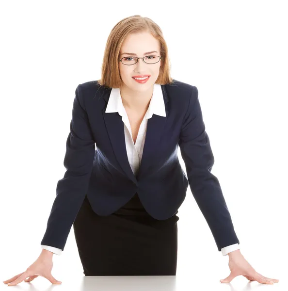Young attractive business woman bending over table. — Stock Photo, Image