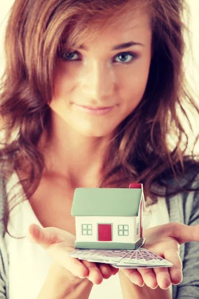 Young woman holding euros bills and house model — Stock Photo, Image