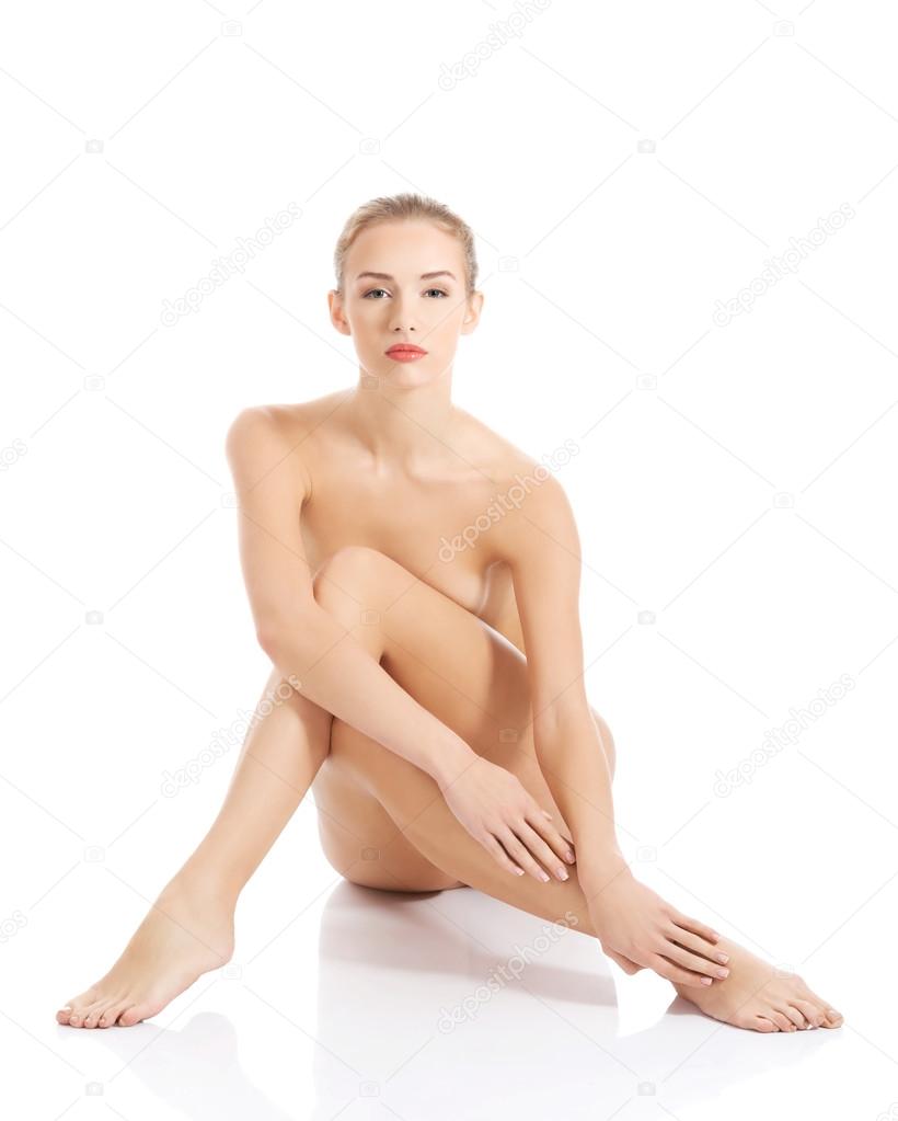 Beautiful caucasian naked woman sitting with fresh clean skin.