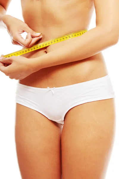 Young woman measuring her waist — Stock Photo, Image