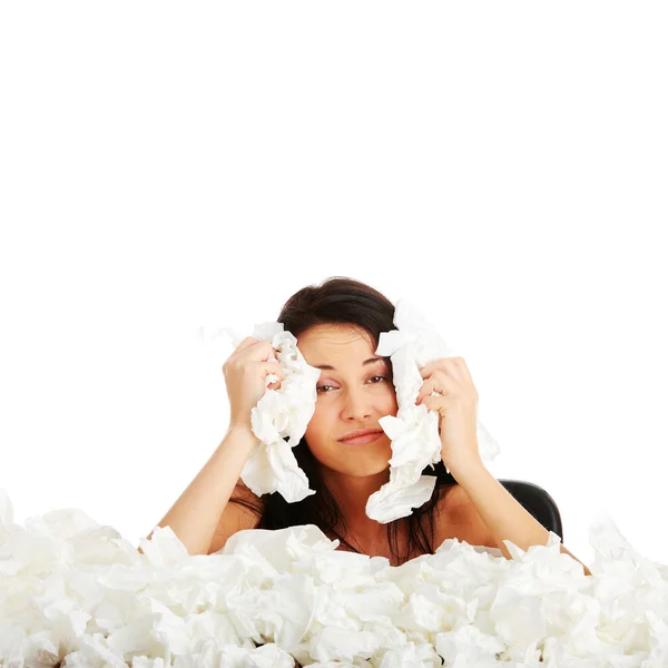 Young woman in lot of tissues around — Stock fotografie