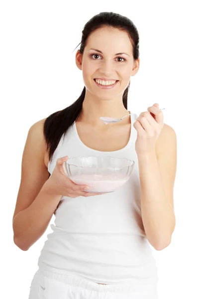 Female eating yoghurt — Stock Photo, Image