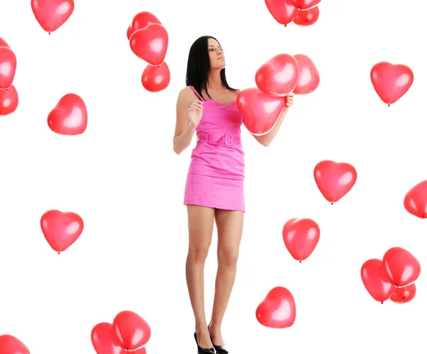 Beautiful young woman with red heart balloon — Stock Photo, Image