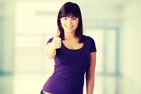 Mujer joven con los pulgares arriba — Foto de Stock