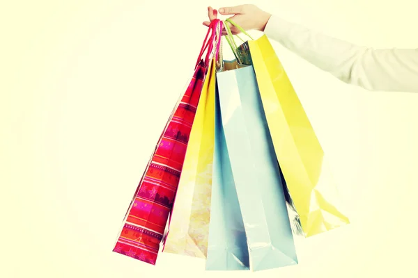 Female hand holding colorful shopping bags — Stock Photo, Image