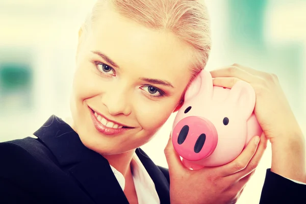 Businesswoman and piggy bank — Stock Photo, Image