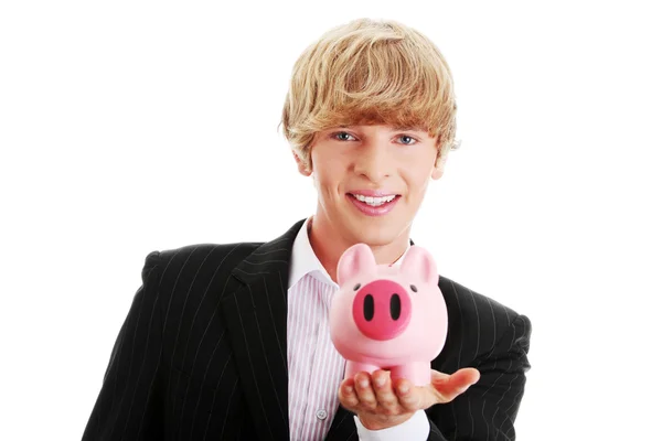 Jonge zakenman met spaarvarken bank — Stockfoto