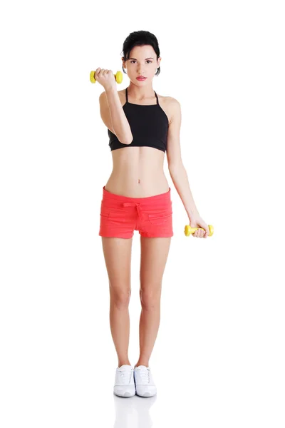 Fitness girl is working out with dumbbells — Stock Photo, Image