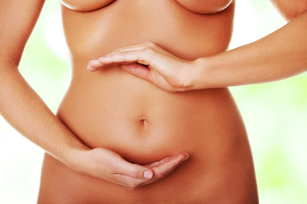 Woman with her hands on her belly — Stock Photo, Image