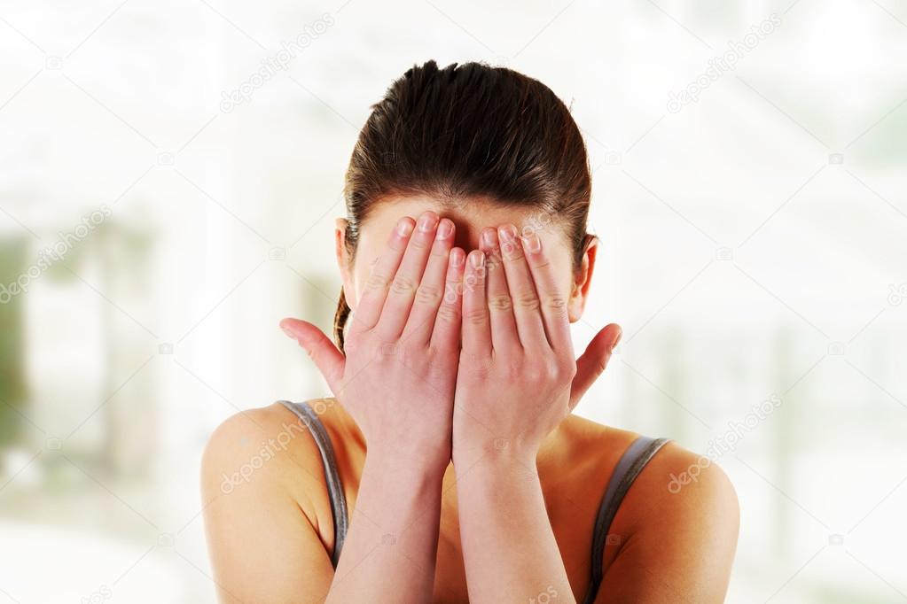 Woman hiding her face in hands