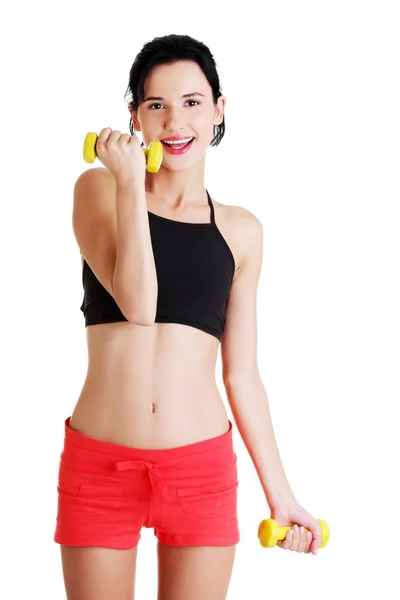 Fitness girl is working out with dumbbells — Stock Photo, Image