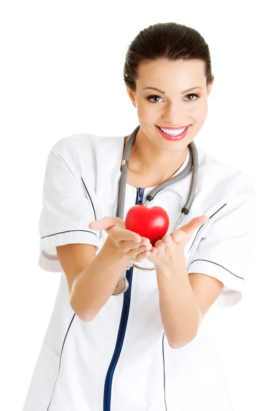 Enfermera joven con el corazón en la mano — Foto de Stock