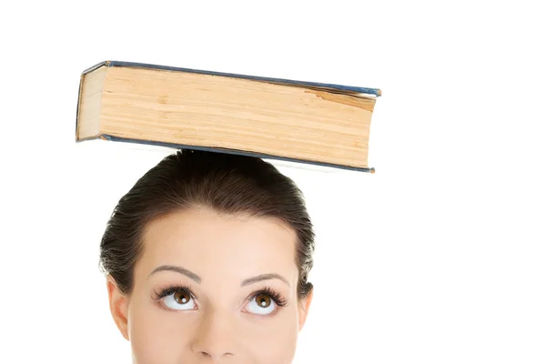 Attractive woman with book on head — Stock Photo, Image