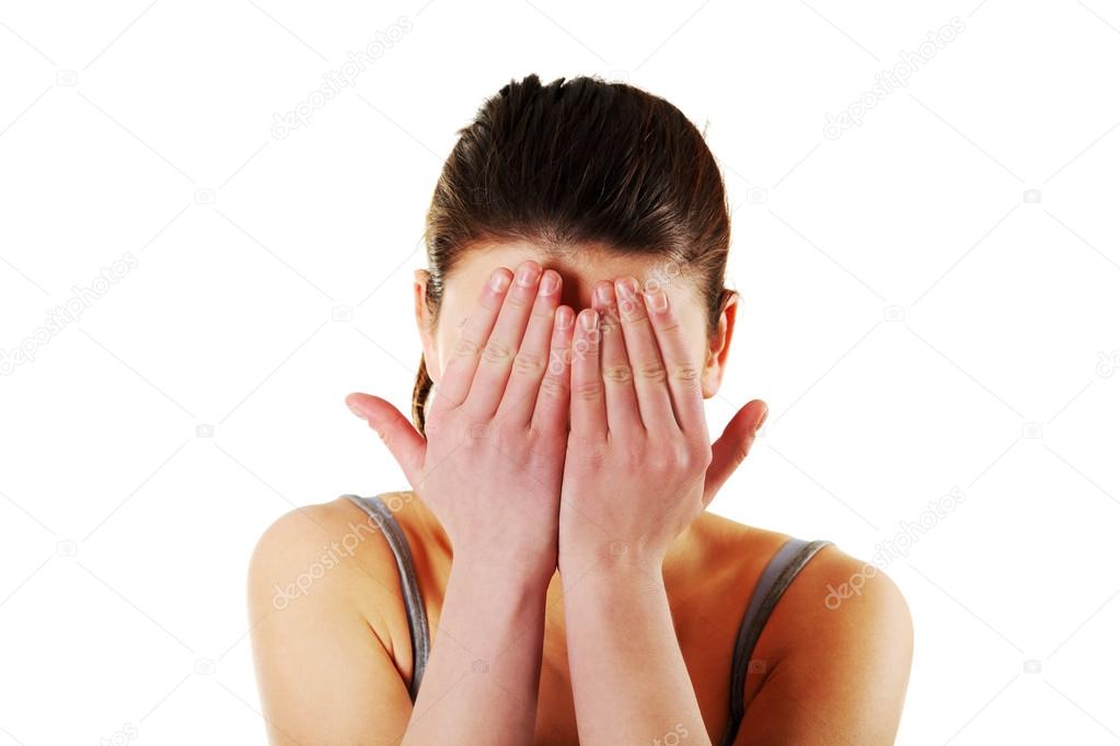 Woman hides face in hands