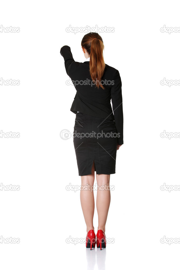 Young businesswoman pointing on copy space