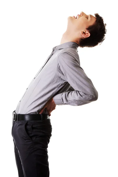 Молодой мужчина с болью в спине — стоковое фото