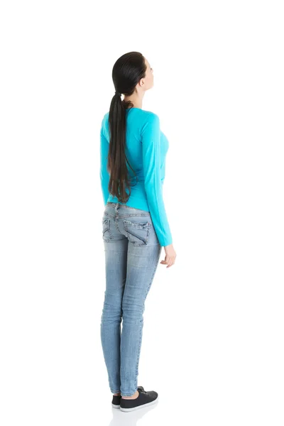 Young casual woman from behind looking up Stock Picture