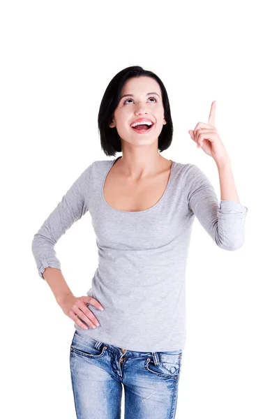 Excited young woman pointing on copy space — Stock Photo, Image