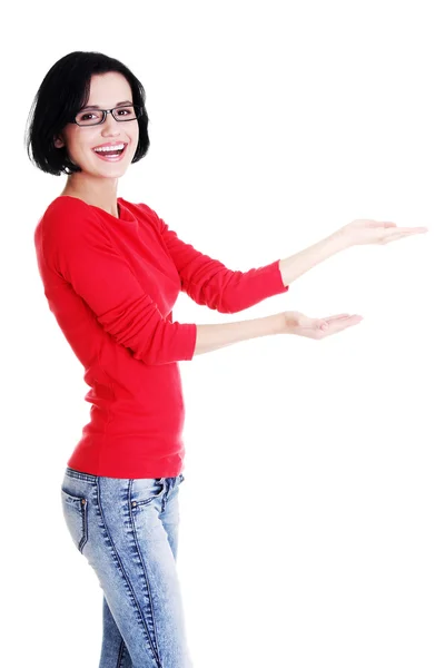 Happy young woman pointing on copy space — Stock Photo, Image