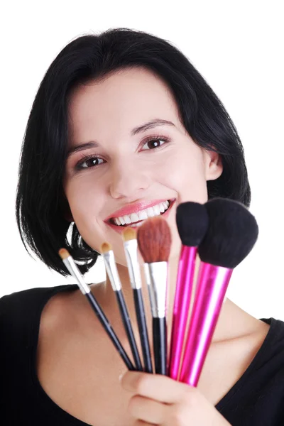 Young make-up artist woman holding brushes — Stock Photo, Image