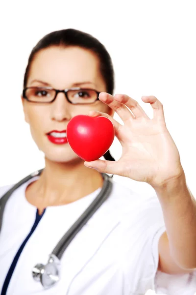 Female doctor holding red heart in hand — Stock Photo, Image