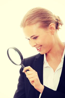 Business woman looking into a magnifying glass clipart
