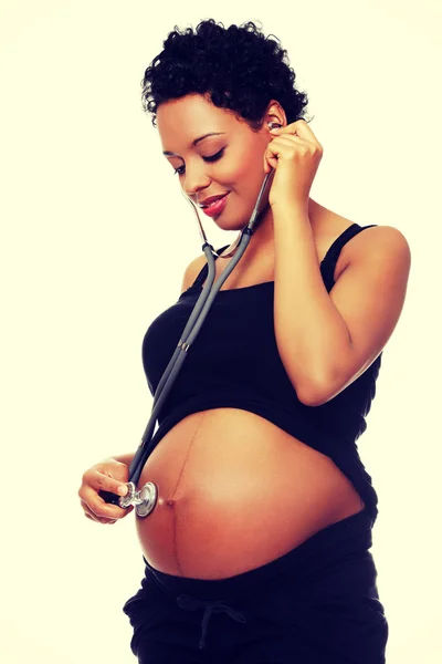 Pregnant woman with stethoscope — Stock Photo, Image