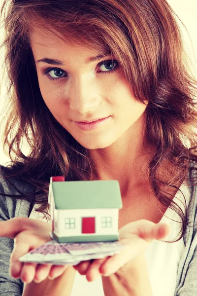 Vrouw met euro rekeningen en huis model — Stockfoto