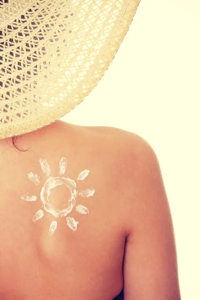Young woman with sun-shaped sun cream — Stock Photo, Image