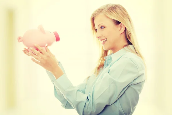 Businesswoman holding piggy bank — Stock Photo, Image