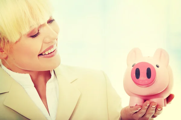 Businesswoman holding piggy bank — Stock Photo, Image