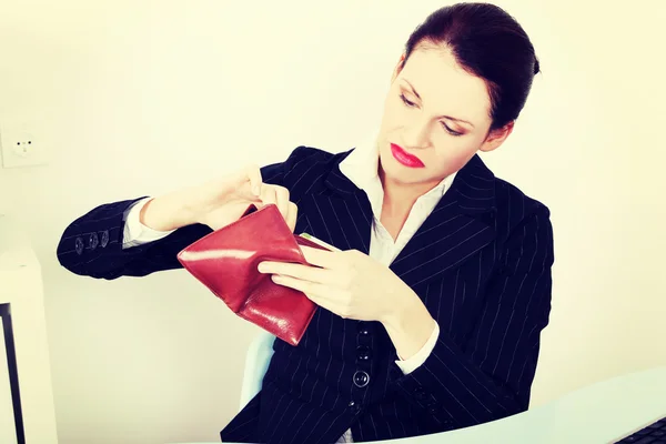 Businesswoman looking at her empty pocket. — Stock Photo, Image