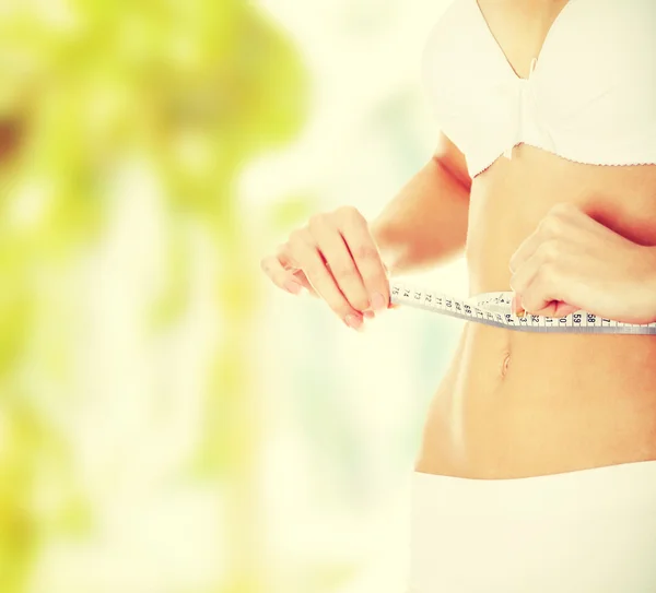 Beautiful woman measuring her perfect shape — Stock Photo, Image