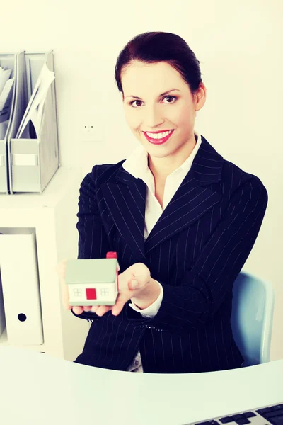 Empresária segurando pequena casa . — Fotografia de Stock