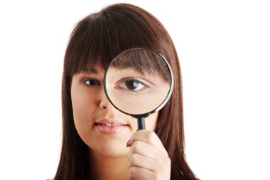 Businesswoman looking into a magniying glass clipart
