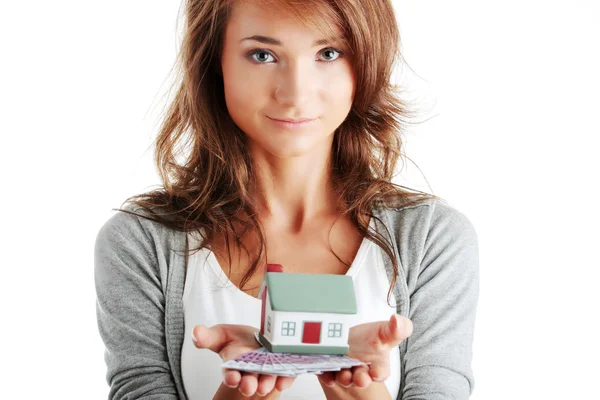 Woman holding euros bills and house model — Stock Photo, Image