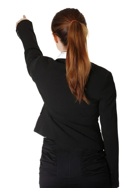 Jeune femme d'affaires pointant sur l'espace de copie — Photo