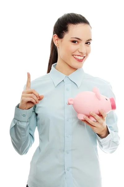 Businesswoman holding piggy bank Stock Picture