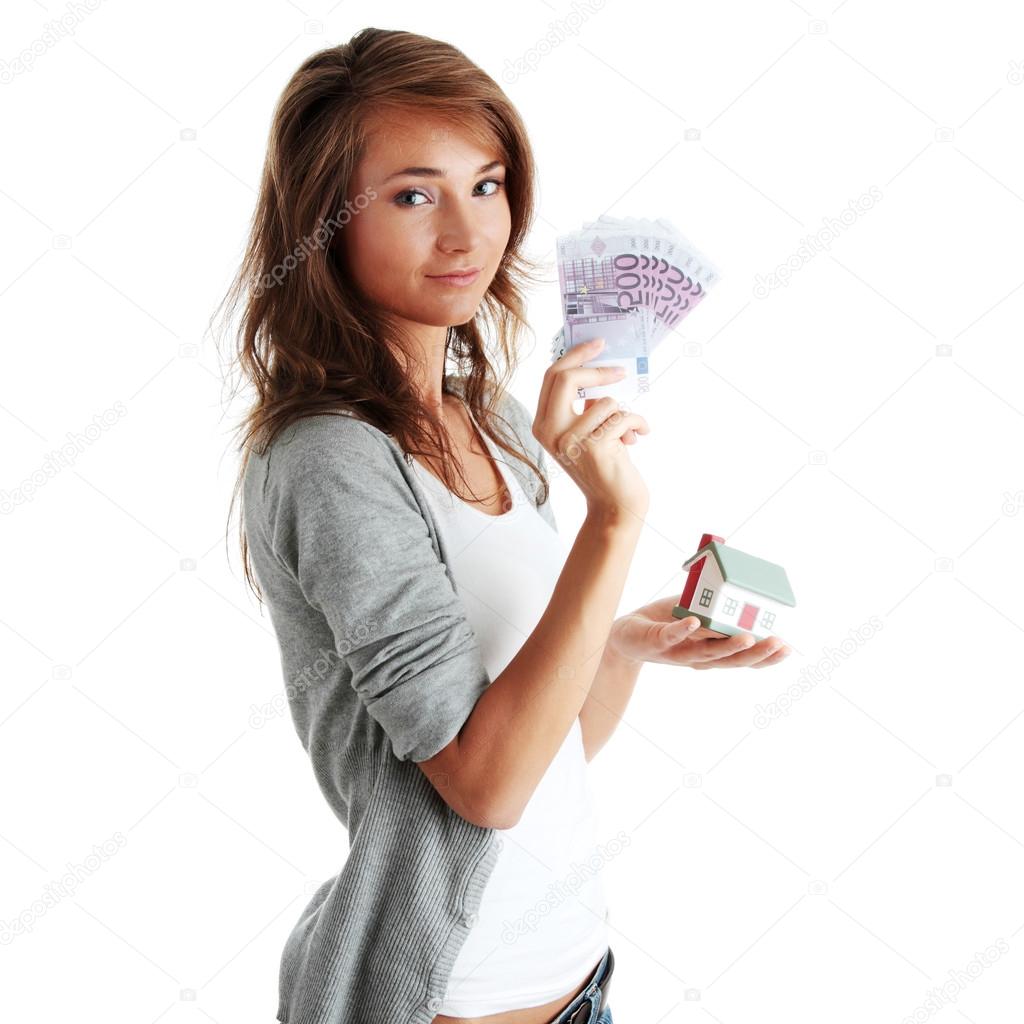 woman holding euros bills and house model
