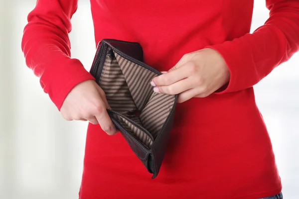 Mujer joven muestra su cartera vacía . — Foto de Stock