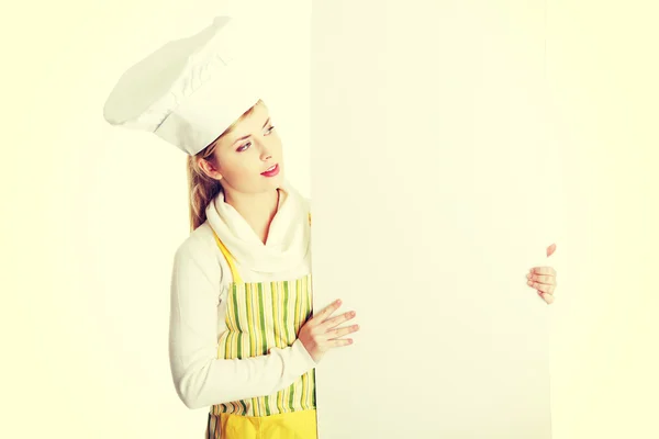 Baker guardando oltre cartellone segno . — Foto Stock