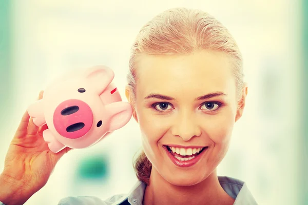 Businesswoman holding piggy bank — Stock Photo, Image