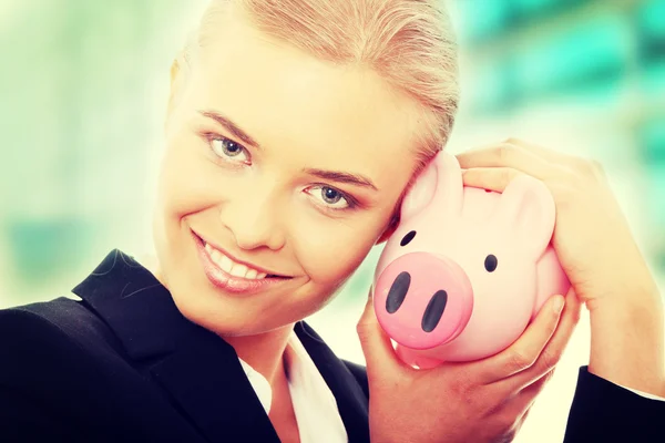 Businesswoman holding piggy bank — Stock Photo, Image