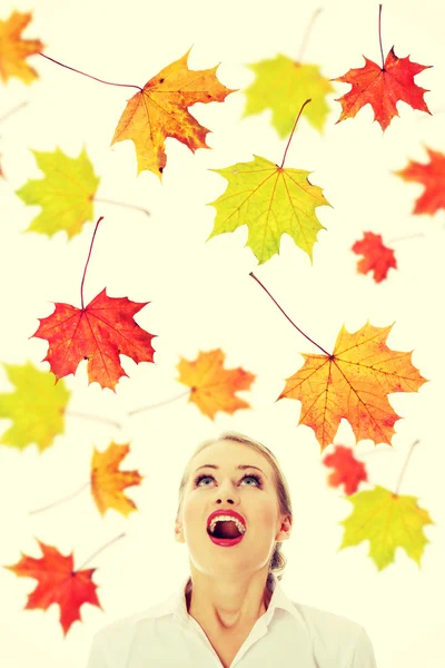 Woman with falling maple leaves — Stock Photo, Image