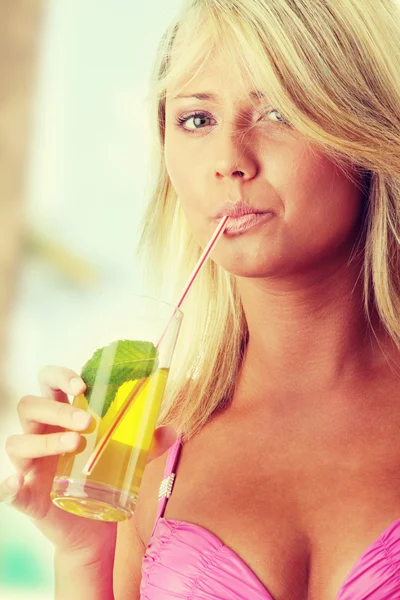 Beautiful young woman in pink bikini with cold drink — Stock Photo, Image