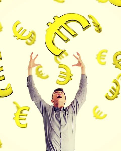Businessman trying to catch falling down euros. — Stock Photo, Image