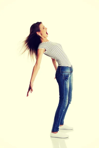 Sonriente adolescente hembra doblando bajo el viento . — Foto de Stock